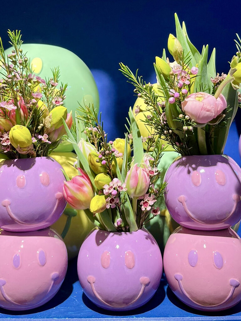 Paarse smiley-vazen met tulpen